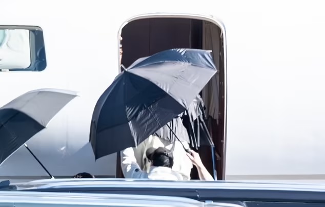 Taylor Swift under umbrella leaving Las Vegas