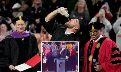 Travis Kelce drinking beer while receiving diploma