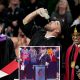 Travis Kelce drinking beer while receiving diploma